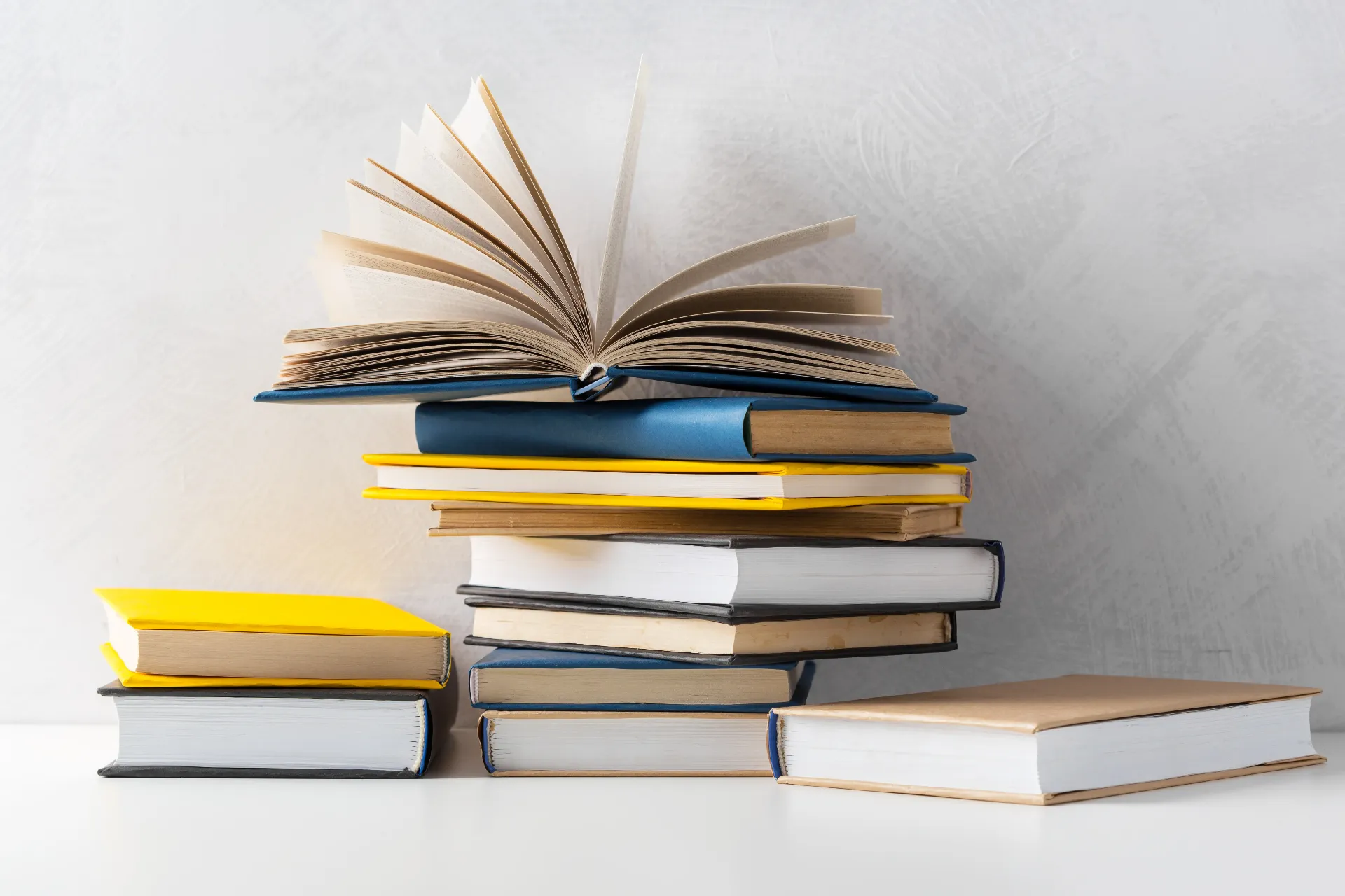 pile-paperback-books-table.webp